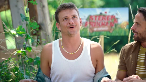 Een foto van Jurre die aan het praten is. Hij kijkt wat omhoog. Naast hem staat een man die naar Jurre kijkt. 