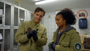 Floris en Stephanie staan naast elkaar, Floris houdt een egeltje in zijn handen, Stephanie kijkt ernaar.