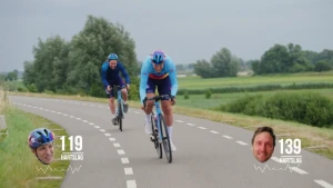 Een foto van twee wielrenners op de weg. Onder in beeld staan twee kleine fotootjes van hun hoofden. Bij het ene hoofd staat hartslag 119. Bij het andere hoofd, dat erg rood is, staat hartslag 139.