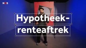 Een foto van presentator Devran in een studio. Hij kijkt in de camera. Voor hem is het woord 'Hypotheekrenteaftrek' te lezen. De studio is blauw uitgelicht en achter hem staat een poster van een vakje op een stembiljet.