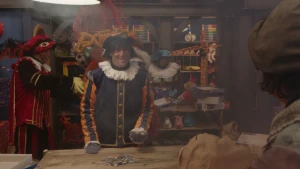 Pietje Paniek staat achter een tafel met puzzelstukjes.