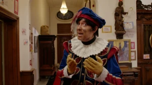 Hoofdpiet gebaart naar de camera.